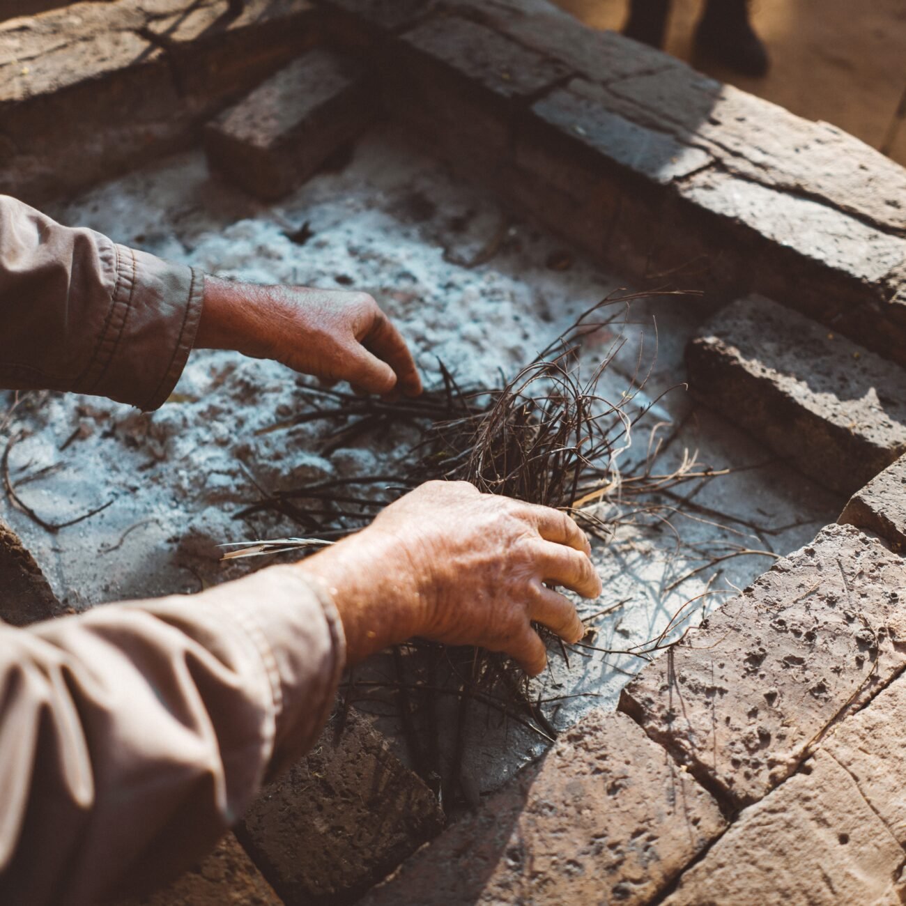hands-gathering-kindling-for-a-fire-pit-2026-03-09-09-18-04-utc